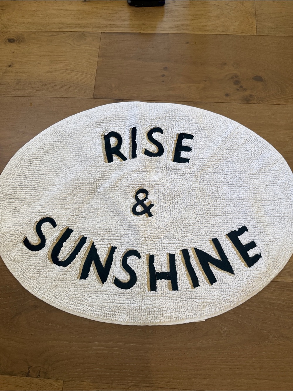Anthropologie White Oval "Rise & Sunshine" Bath Mat